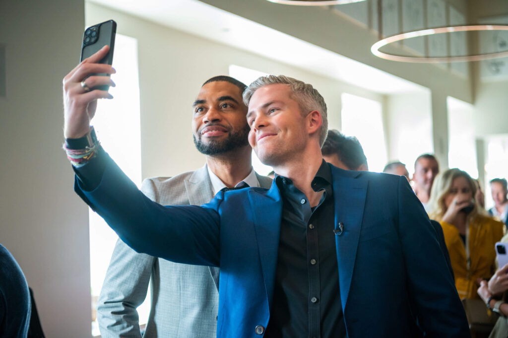 Ryan Serhant and male guest taking selfie photo at Mastermind Event New York City