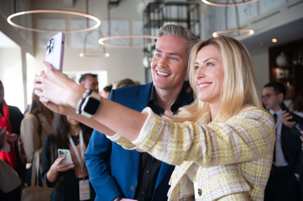 Ryan Serhant and female guest taking selfie at Sell It Like Serhant Mastermind Event